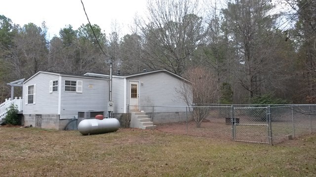 177 Cyler Road Gray, GA 31032 - Photo 3 of 15 a backyard of a white house with table and chairs and a large tree