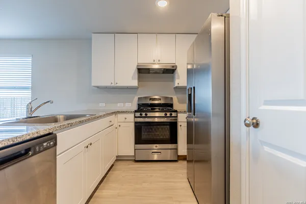 a kitchen with a stove and a refrigerator