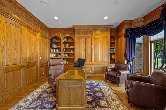 a kitchen with stainless steel appliances kitchen island granite countertop a dining table chairs sink refrigerator and cabinets