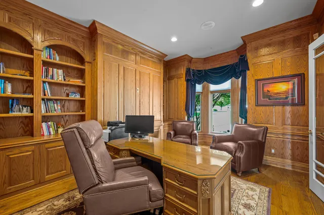a kitchen with a refrigerator and white cabinets