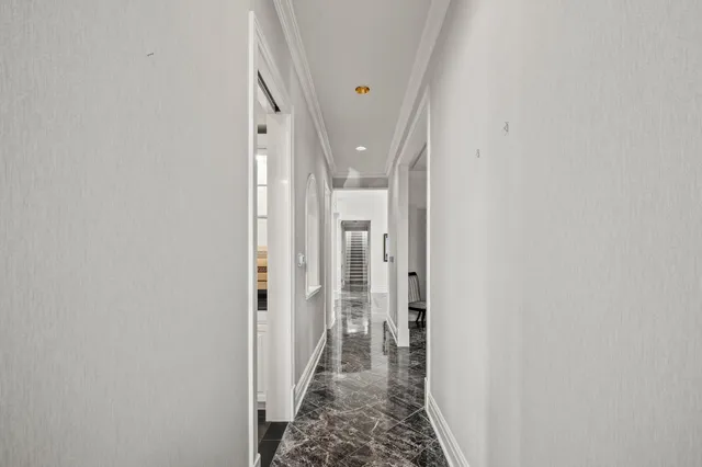 a dining room with furniture a chandelier and window