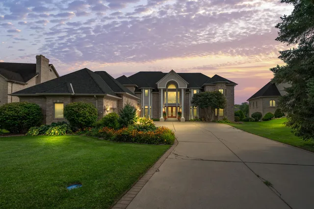 a front view of a house with a garden