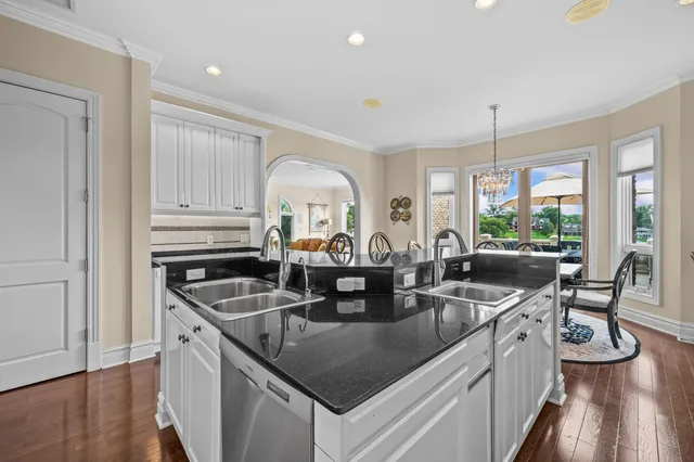 a kitchen with stainless steel appliances granite countertop a stove sink and cabinets