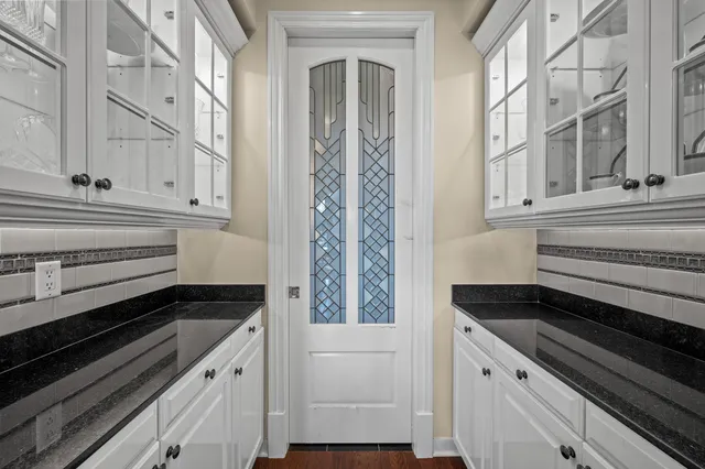 a living room with patio furniture and garden view