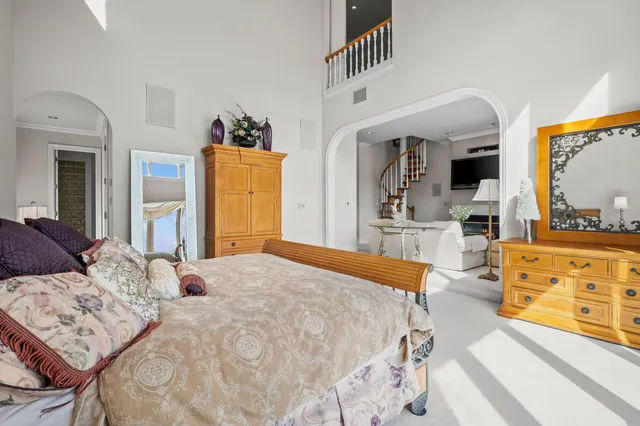 a view of a white house with a yard and sitting area