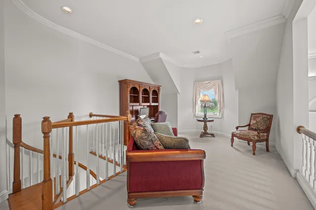 an aerial view of a house with a garden and lake view