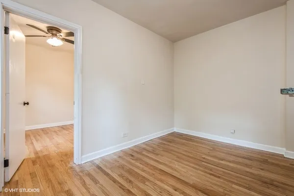 a view of a room with wooden floor