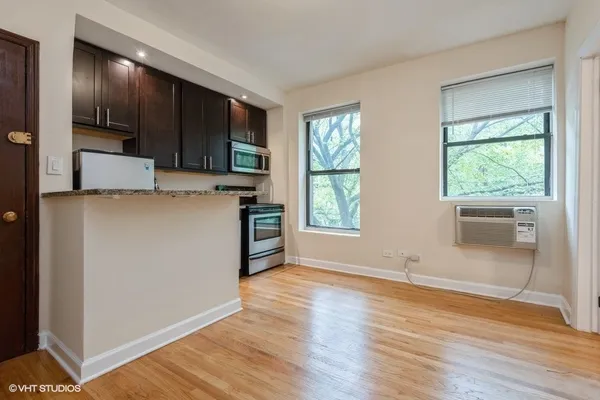 a view of kitchen with wooden floor and electronic appliances