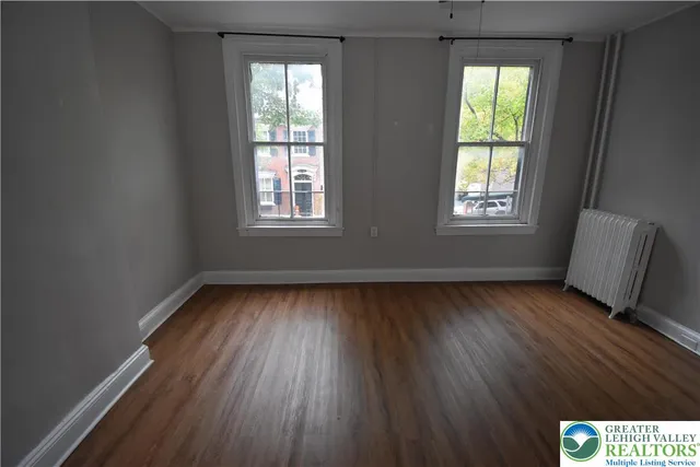 a view of room window and wooden floor