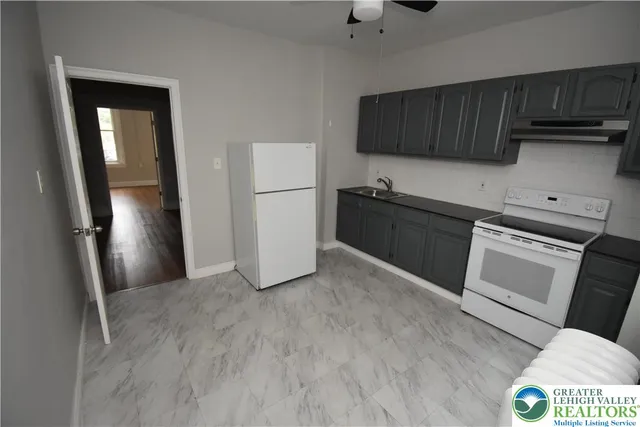 a kitchen with a refrigerator and a sink
