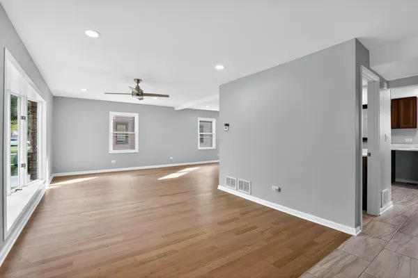 wooden floor in an empty room with a window