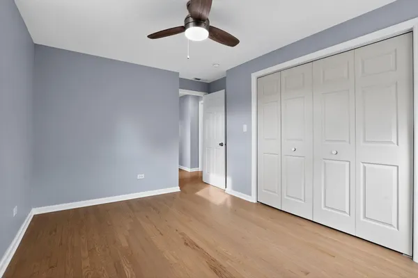 a view of an empty room with a ceiling fan