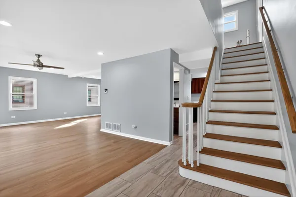 a view of entryway with wooden floor and stairs