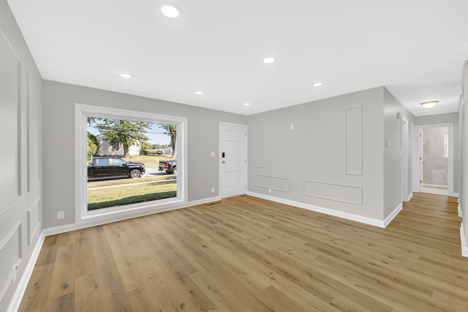 835 Parkside Circle Streamwood, IL 60107 - Photo 4 of 23 a view of an empty room with wooden floor and a window