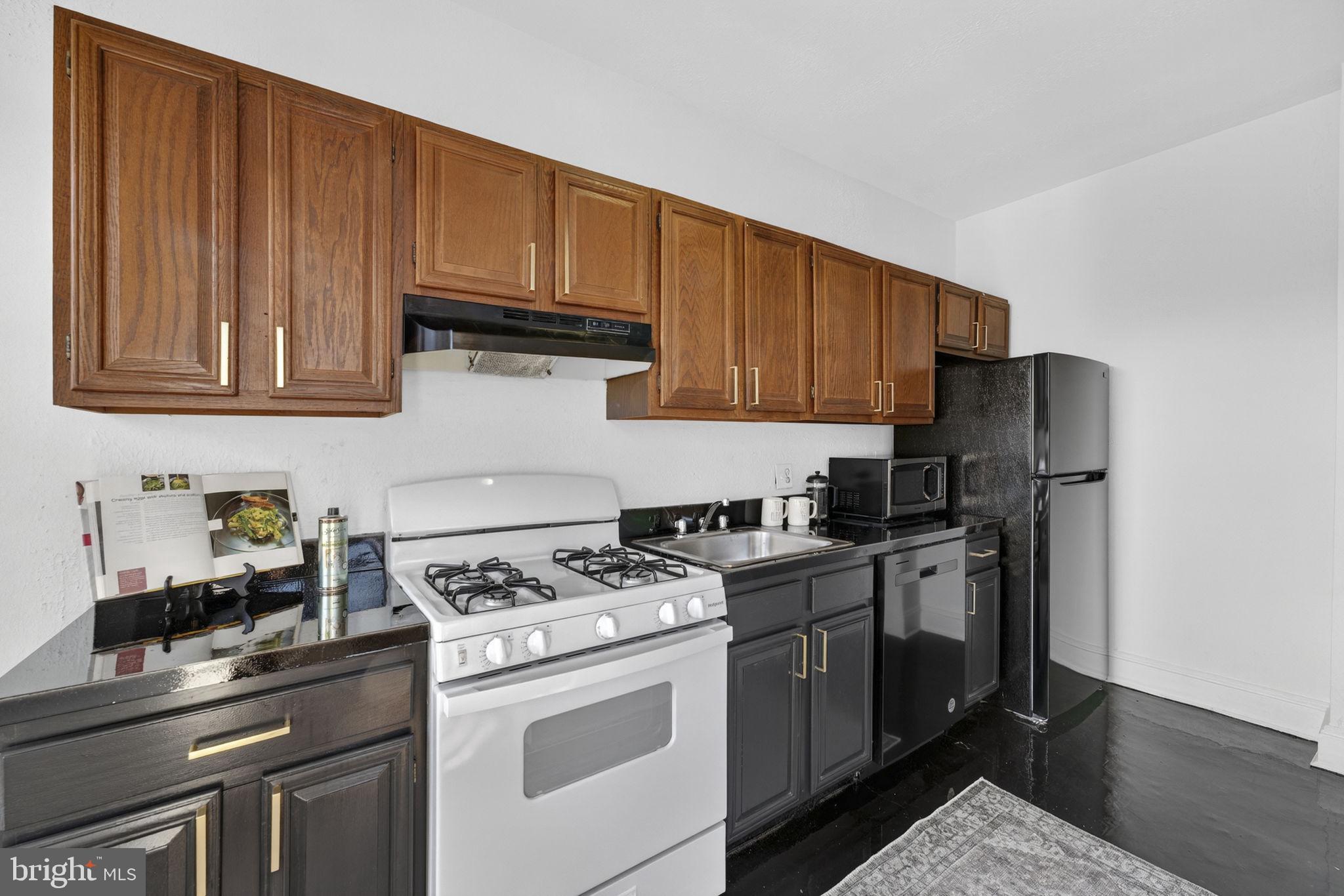644 Massachusetts Avenue Northeast, Unit 406 Washington, DC 20002 - Photo 12 of 31 a kitchen with stainless steel appliances granite countertop a stove a refrigerator and a cabinets