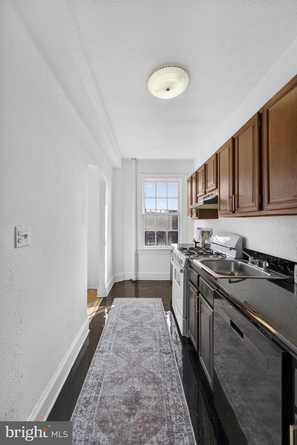 644 Massachusetts Avenue Northeast, Unit 406 Washington, DC 20002 - Photo 14 of 31 a kitchen with stainless steel appliances granite countertop a stove a sink dishwasher and a refrigerator