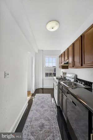 a kitchen with stainless steel appliances granite countertop a stove a sink dishwasher and a refrigerator