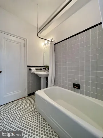 a bathroom with a sink a toilet a mirror and shower