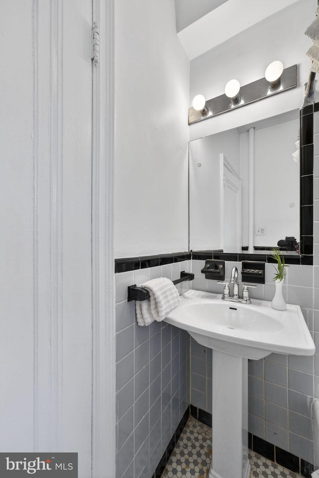 644 Massachusetts Avenue Northeast, Unit 406 Washington, DC 20002 - Photo 21 of 31 a bathroom with a sink and a mirror