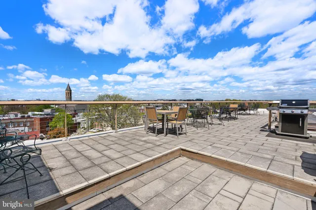a view of a terrace with lawn chairs