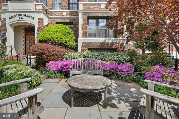 a view of a chairs and table in backyard of the house
