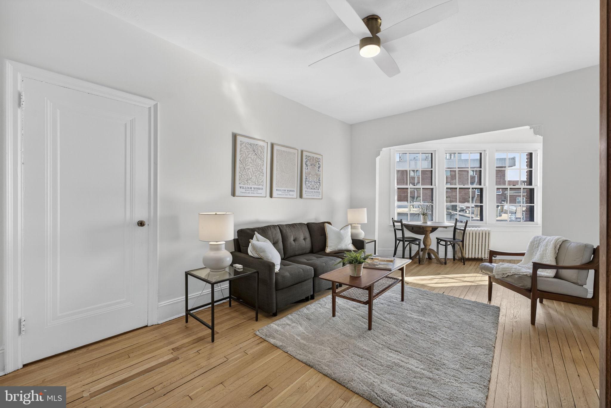 644 Massachusetts Avenue Northeast, Unit 406 Washington, DC 20002 - Photo 5 of 31 a living room with furniture and a wooden floor