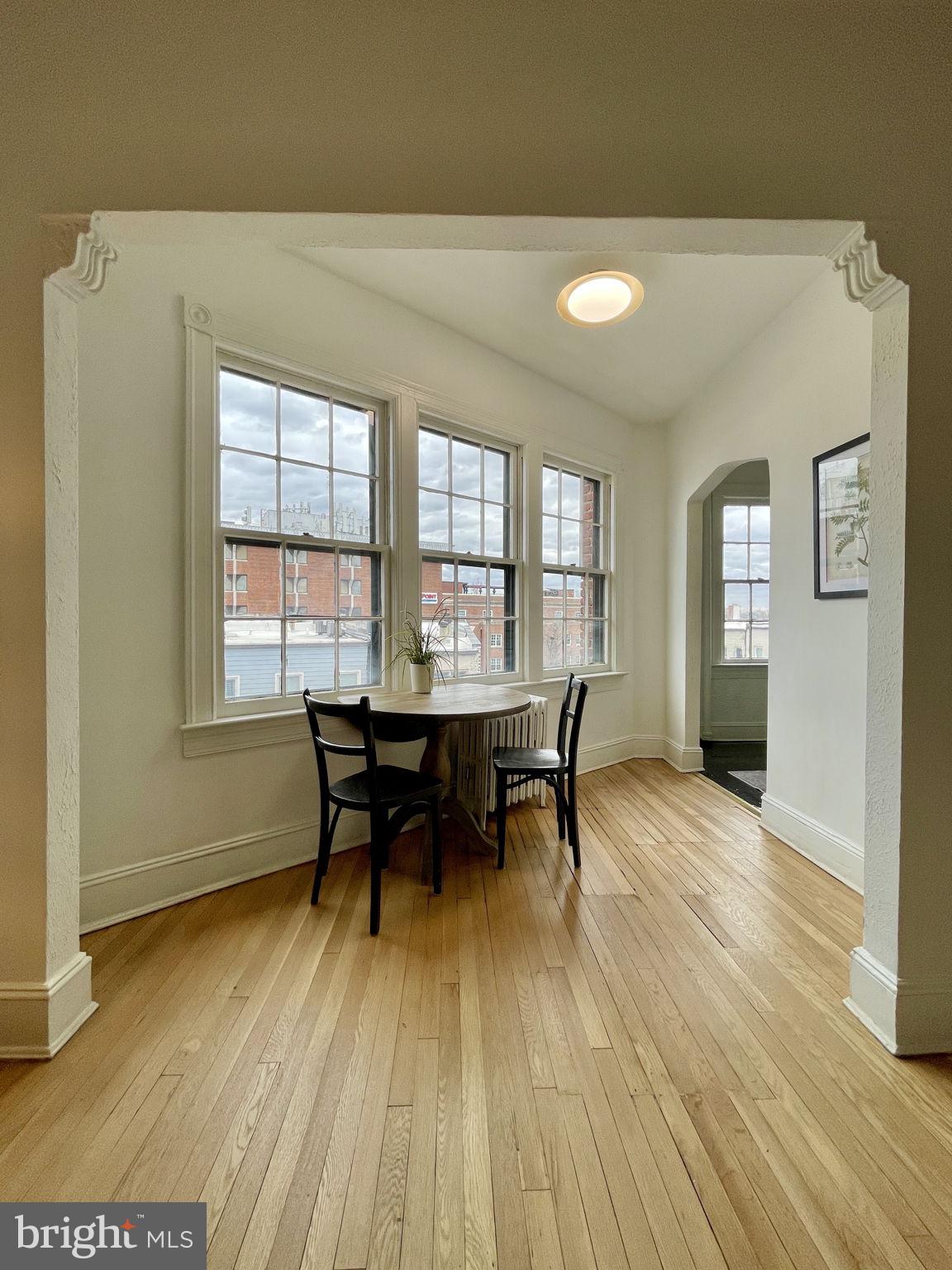 644 Massachusetts Avenue Northeast, Unit 406 Washington, DC 20002 - Photo 8 of 31 a view of a dining room with furniture and wooden floor