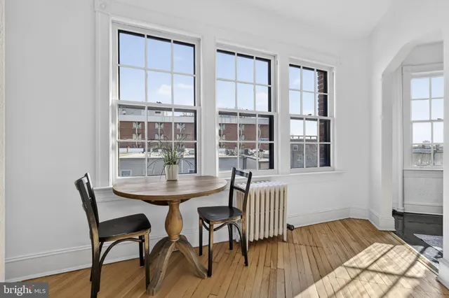 a view of a dining room with furniture and windows