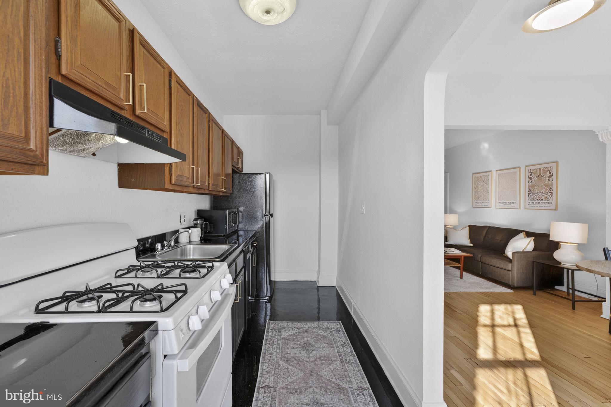 644 Massachusetts Avenue Northeast, Unit 406 Washington, DC 20002 - Photo 10 of 31 a kitchen with a stove and a refrigerator