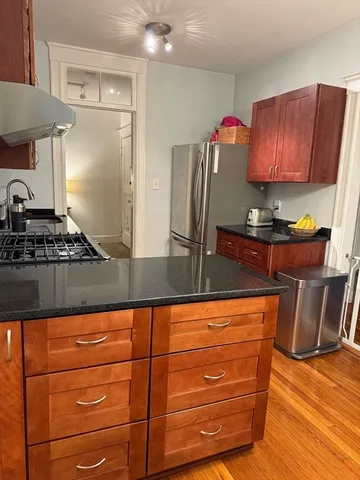 a kitchen with granite countertop a stove and cabinets