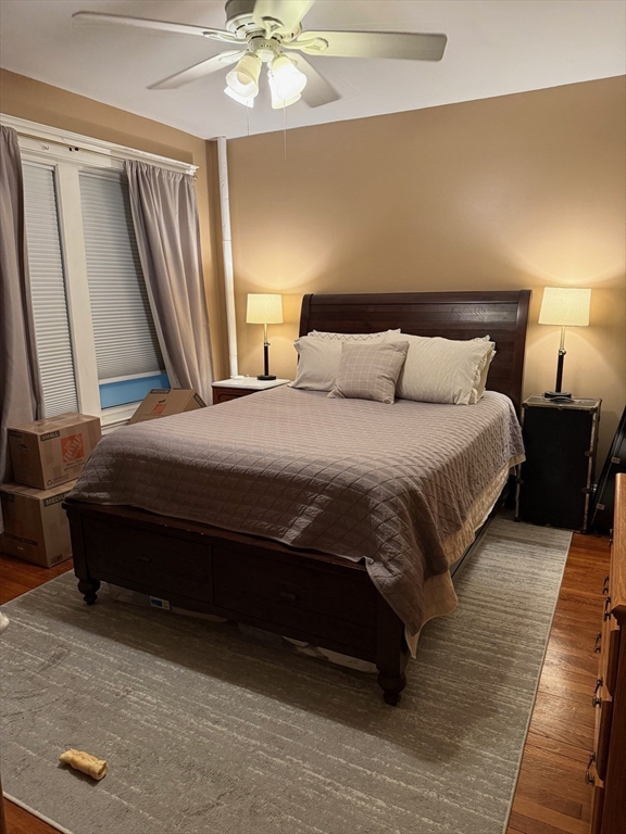 11 Vinal Street, Unit 3 Boston, MA 02135 - Photo 6 of 10 a bedroom with a bed and a chandelier