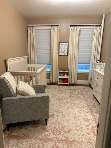 a living room with a couch and a dresser