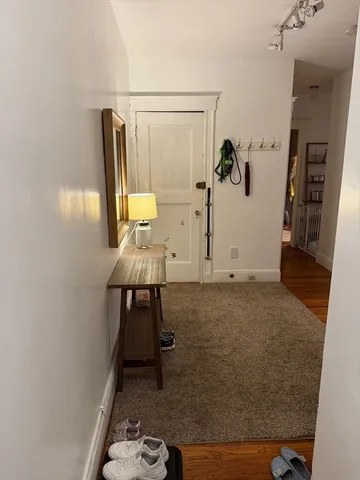 a view of a hallway with paintings on the wall