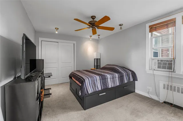 a spacious bedroom with a bed and a flat screen tv