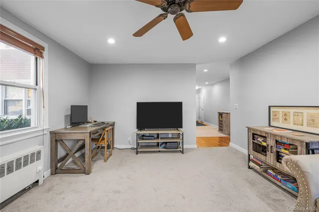 a view of a livingroom with furniture and a flat screen tv