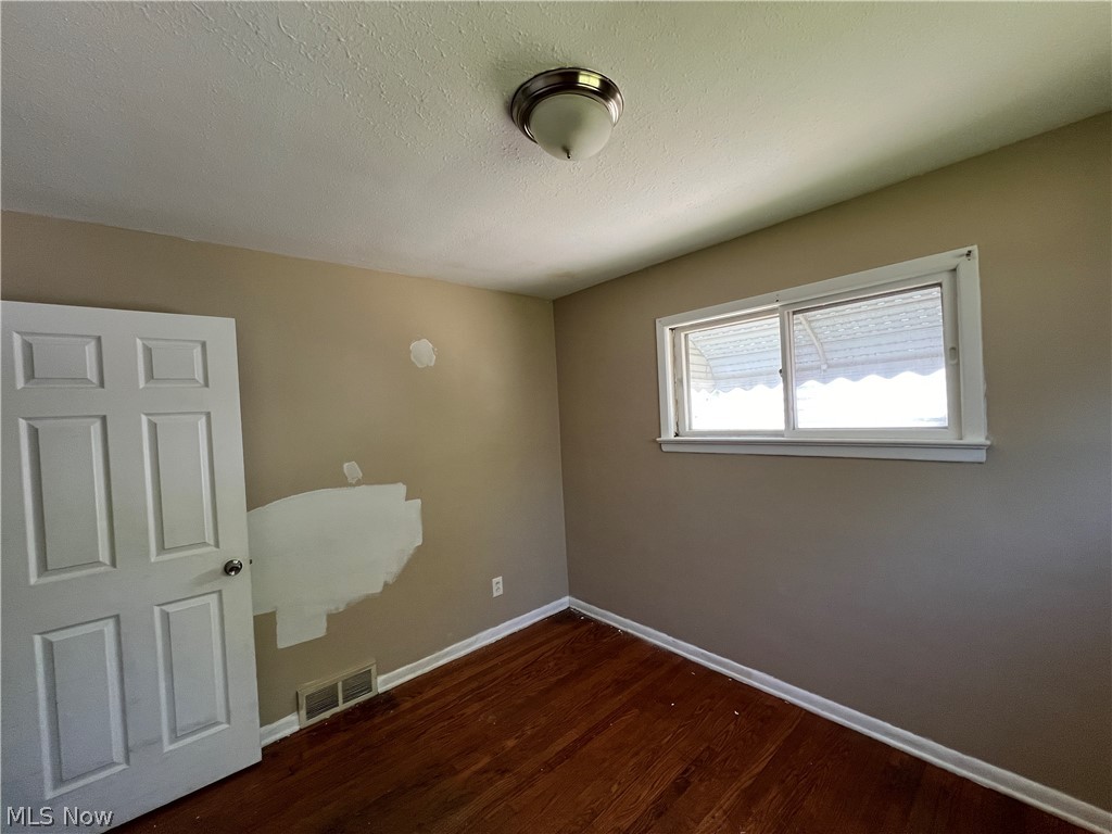 20731 Donnybrook Road Maple Heights, OH 44137 - Photo 8 of 17 Spare room featuring hardwood / wood-style flooring