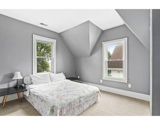 22 Spring Street Everett, MA 02149 - Photo 7 of 13 a bedroom with a bed and a large window