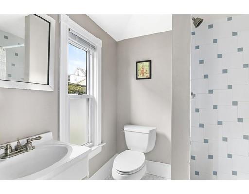 22 Spring Street Everett, MA 02149 - Photo 9 of 13 a bathroom with a toilet a sink and mirror