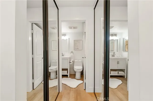 a bathroom with a granite countertop toilet and a sink
