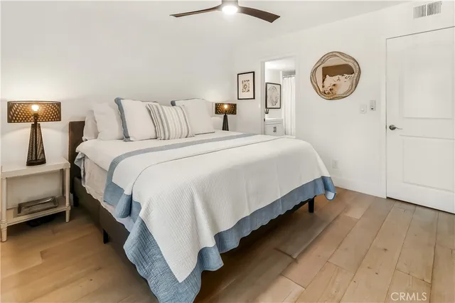 a large bed sitting in a bedroom next to a lamp