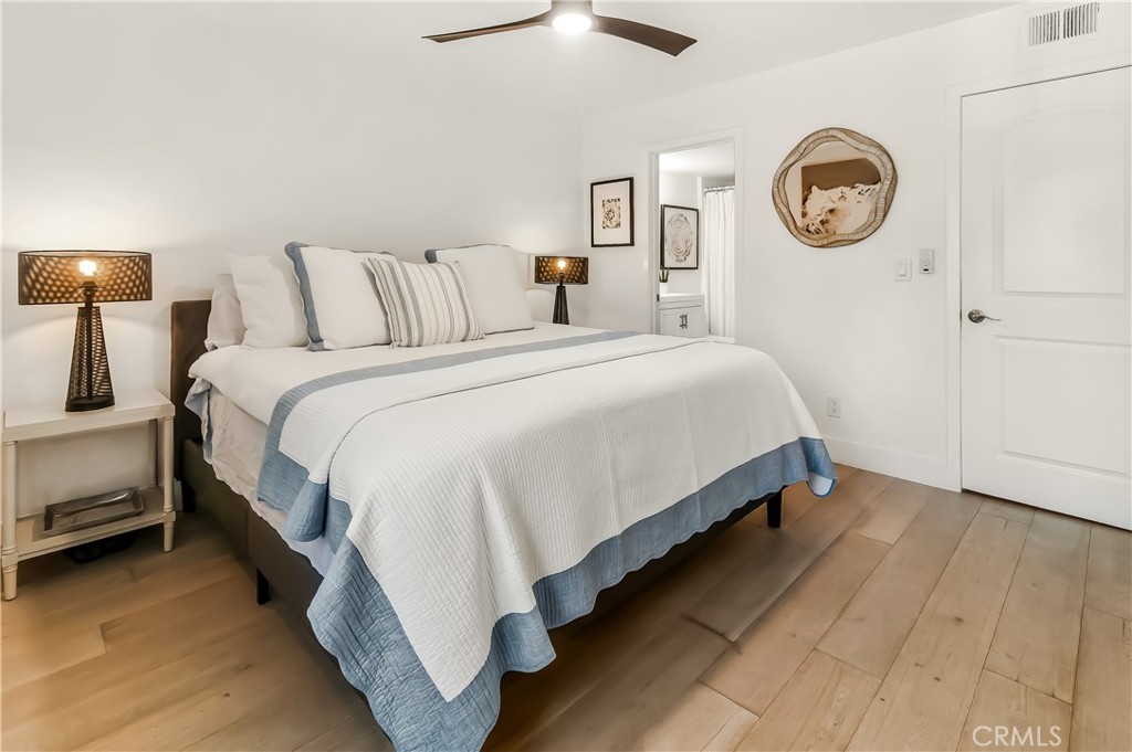 33852 Del Obispo Street, Unit 2 Dana Point, CA 92629 - Photo 14 of 30 a large bed sitting in a bedroom next to a lamp