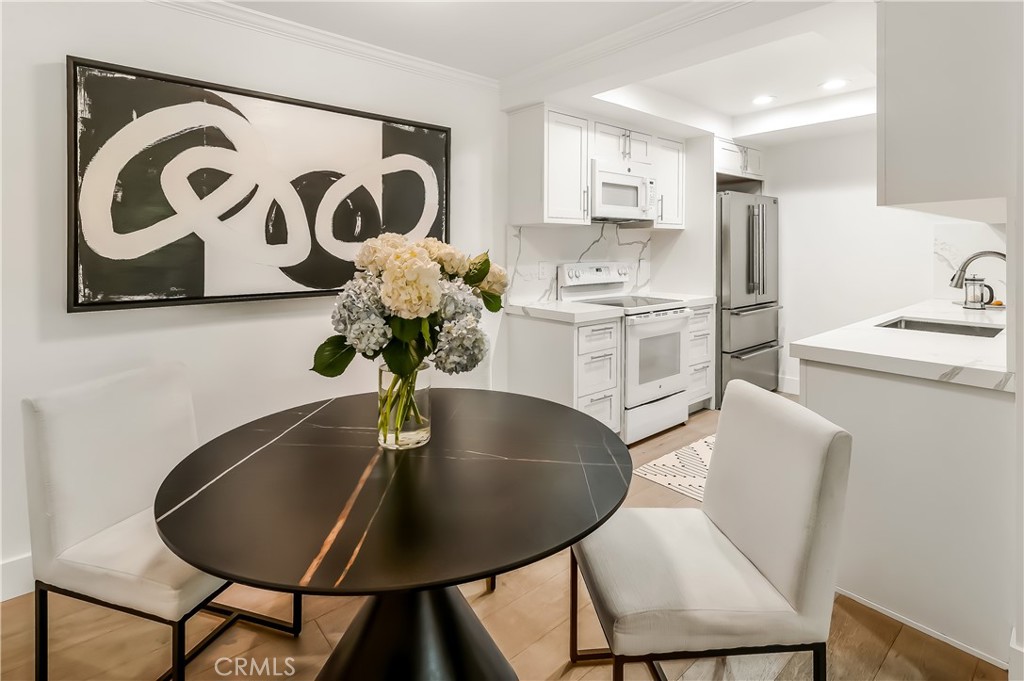 33852 Del Obispo Street, Unit 2 Dana Point, CA 92629 - Photo 18 of 30 a kitchen with a table and chairs