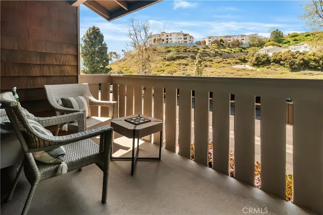a roof deck with table and chairs