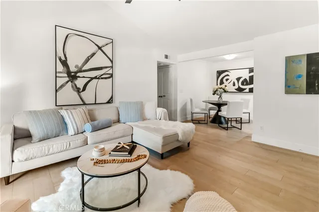 a living room with furniture and a white wall