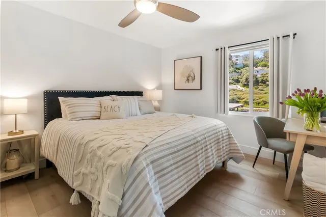 a bedroom with a bed lamps and window