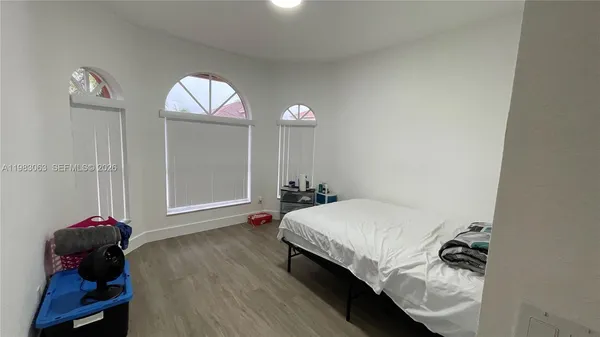 a bedroom with a bed and a mirror