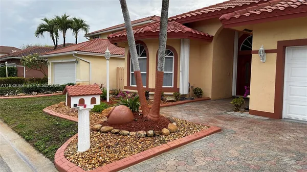 a front view of a house with garden