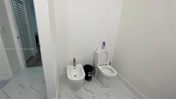 a bathroom with a toilet and a sink