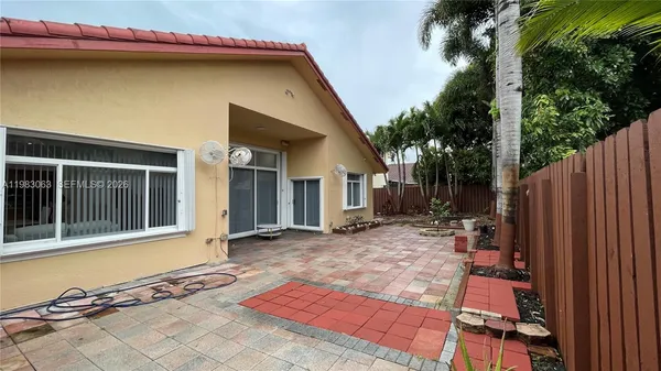 a view of a house with backyard and sitting area