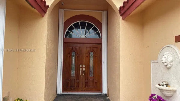 a view of front door with wooden door